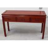 A contemporary Chinese hardwood hall table with three drawers, width 122cm.