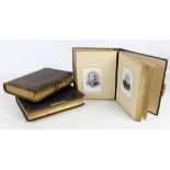 Three Victorian leather bound photograph albums,