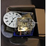 A quantity of clock parts including wall clock dials and movements, longcase clock backplate, etc.