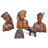 Three Balinese hardwood carvings modelled as figures, height 29cm, and two further carvings (5).