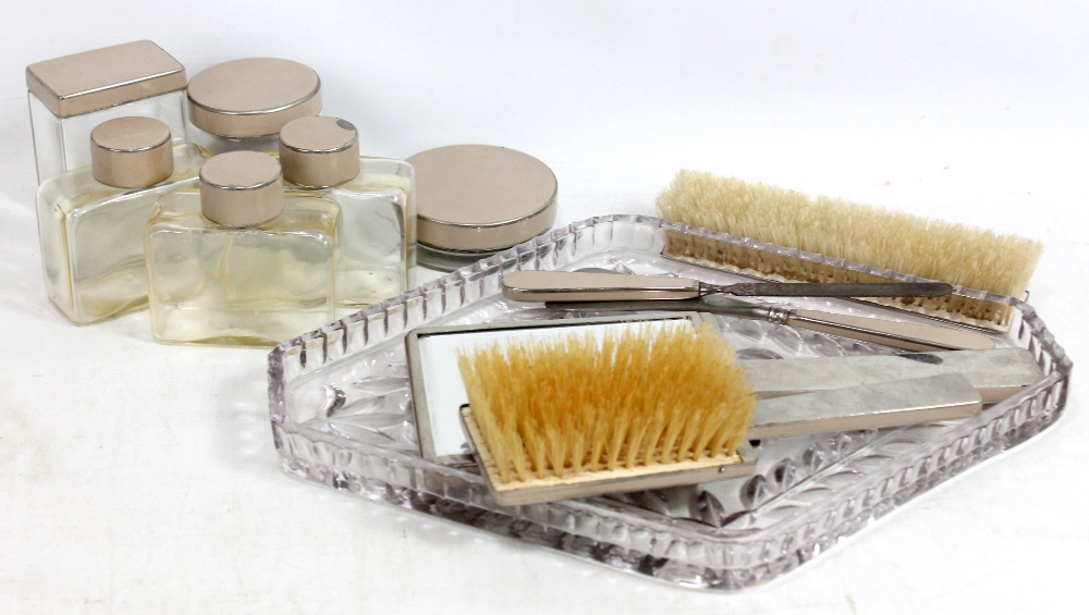 A gentleman's dressing table set, comprising cut glass tray, brushes, show horn, scent bottles,