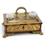 A rosewood and brass inlaid inkstand with central handle,