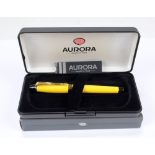 An Aurora Italy fountain pen in yellow and black with gilt detail, boxed.