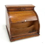An early 20th century oak tambour fronted stationery box, width 31cm.