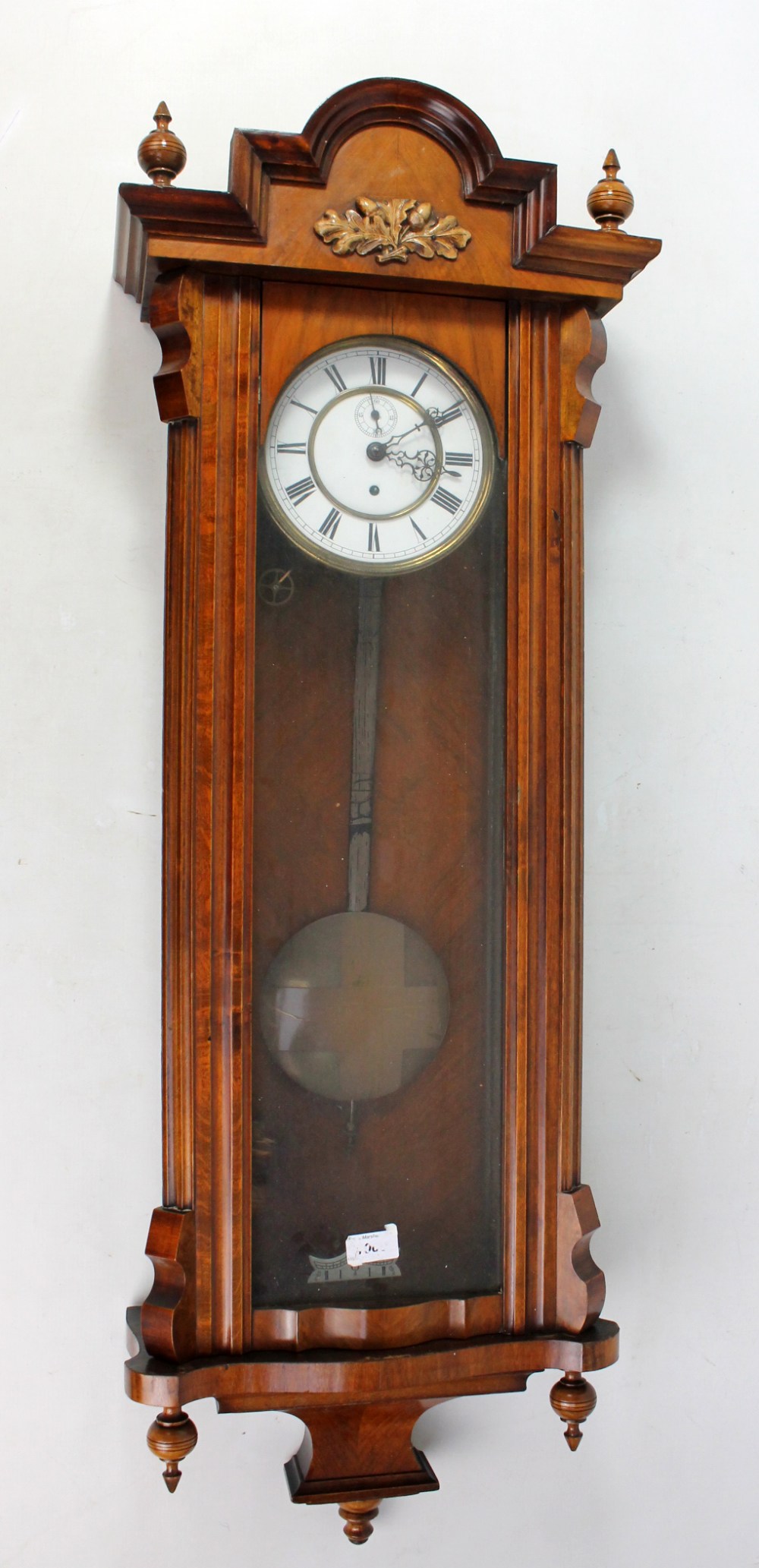A circa 1900 walnut and beech Vienna style wall clock with two-piece white enamel dial set with