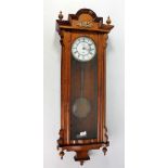 A circa 1900 walnut and beech Vienna style wall clock with two-piece white enamel dial set with