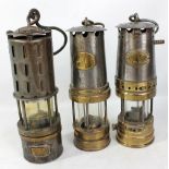 Three flame safety lamps, one bearing plaque inscribed 'Patterson Lamps Ltd Type GTL9P,