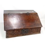 An 18th century oak bible box, initialled 'DH' to the hinged lid above carved frieze, width 63cm.