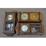Two 1940s oak wall clocks and a more modern example (3).