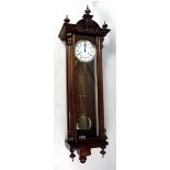 A reproduction walnut and beech twin weight Vienna style wall clock.