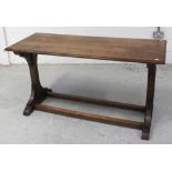 An early 20th century oak hall/church table on slab-end supports and cross-stretcher, length 143cm.