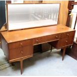 A 1960s teak dressing table by MacIntosh with central swing mirror above thee over two drawers,