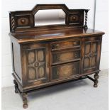 A small 1930s oak mirror-back sideboard with barleytwist column supports over a twin cupboard base