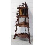 A Victorian walnut four tier corner what not with pierced fretwork gallery over a graduated pie