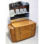 A c1950s Art Deco style oak mirror back dressing table, bow front with three drawers,