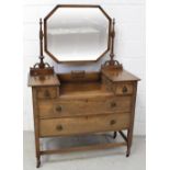 A 1930s drop-centre dressing chest with octagonal swing mirror over a two-over-two drawer