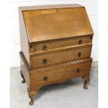 A 1930s walnut bureau with cascade front on shell carved cabriole legs, height 105cm.