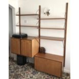 A 1960s G-Plan style teak wall mounted shelf and cabinet unit.