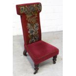 A Victorian prie dieu chair covered with maroon ground fine point floral tapestry,