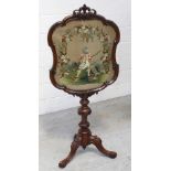 A mid Victorian mahogany pedestal fire screen with carved fleur-de-lys cartouche above an