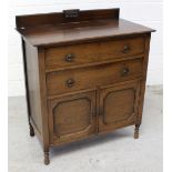 An early 20th century oak tallboy cabinet,