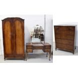 A c1950s three piece mahogany bedroom suite comprising a mirror back kneehole dressing table,