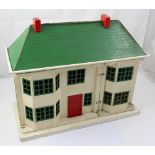 A small c1930s Tri-ang dolls' house with metal-framed windows and doors, unfurnished, width 55cm.