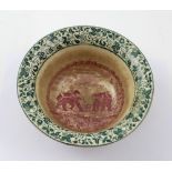 An early 20th century puce bat printed bowl with decoration to the centre of Thai fighting