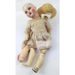 An early 20th century Belgian Unica porcelain head doll, blue painted eyes, open mouth with teeth,