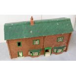 A large scratch-built hardboard dolls' house with metal window and door frames, width 84.5cm.
