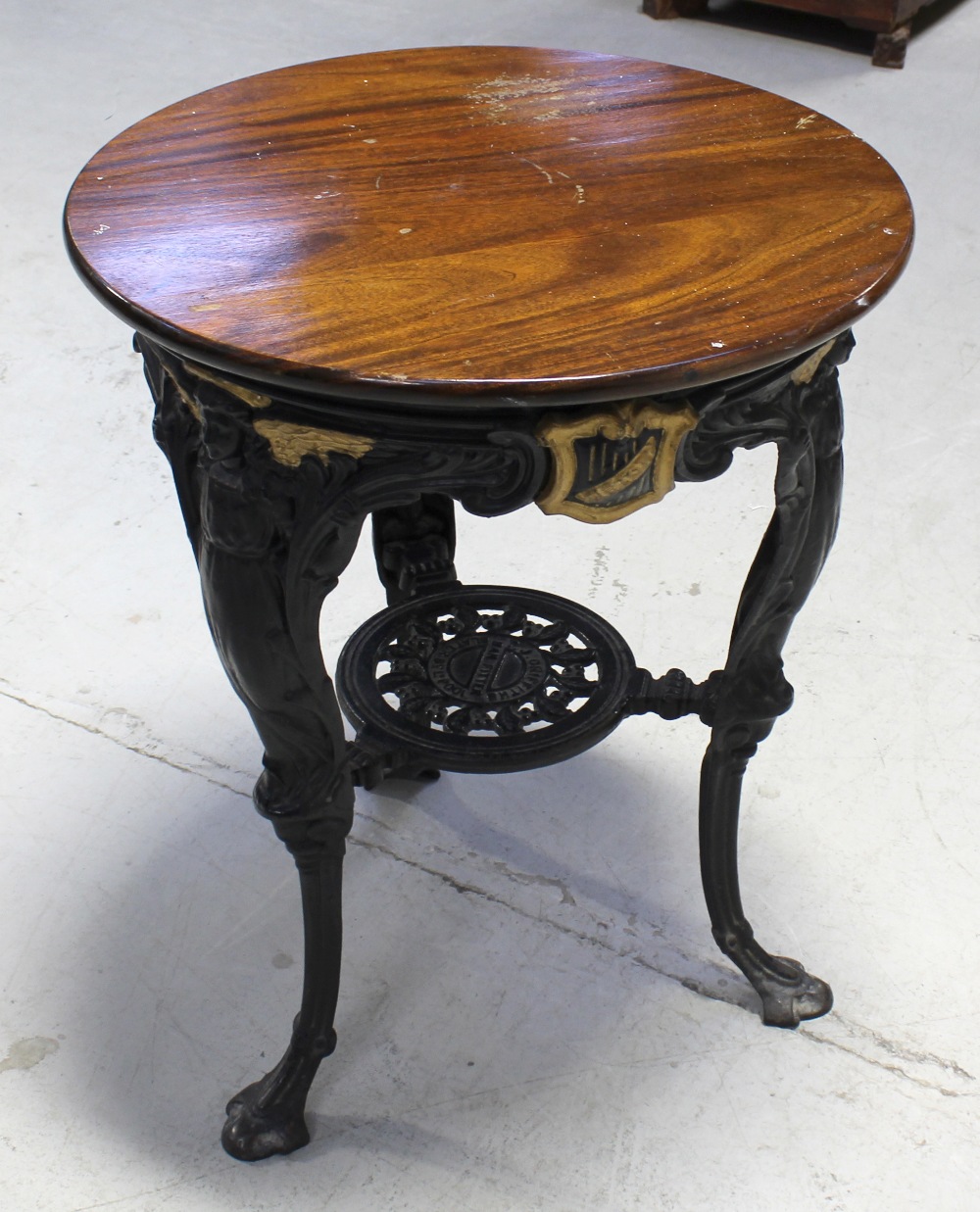 A cast iron Britannia table by T J Griffiths of Liverpool, with a later top, diameter 61cm.