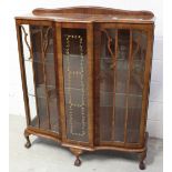 An early 20th century walnut glazed display cabinet on claw and ball supports, width 105cm.