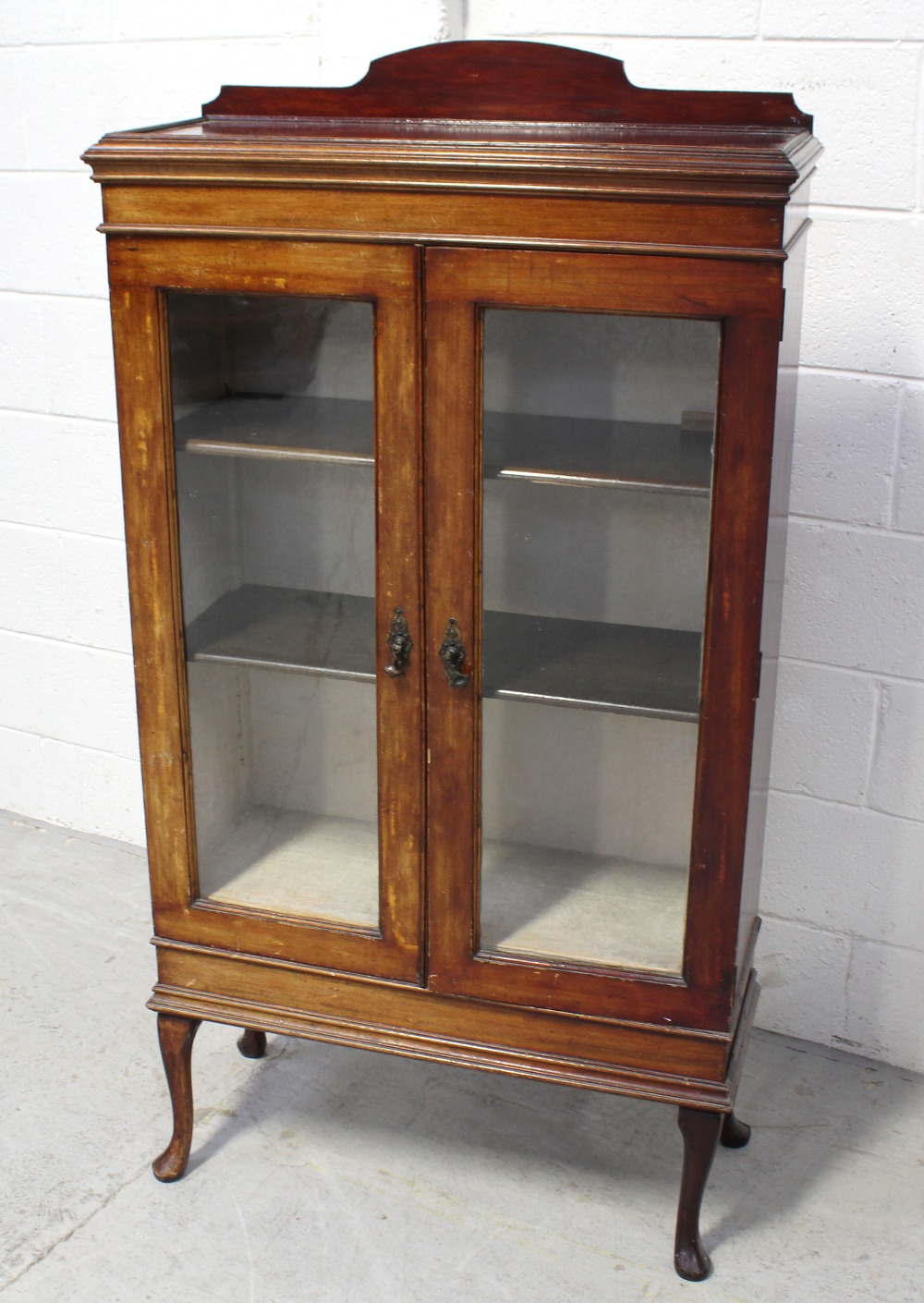 An early 20th century mahogany glazed display case raised on cabriole supports, width 72.5cm.