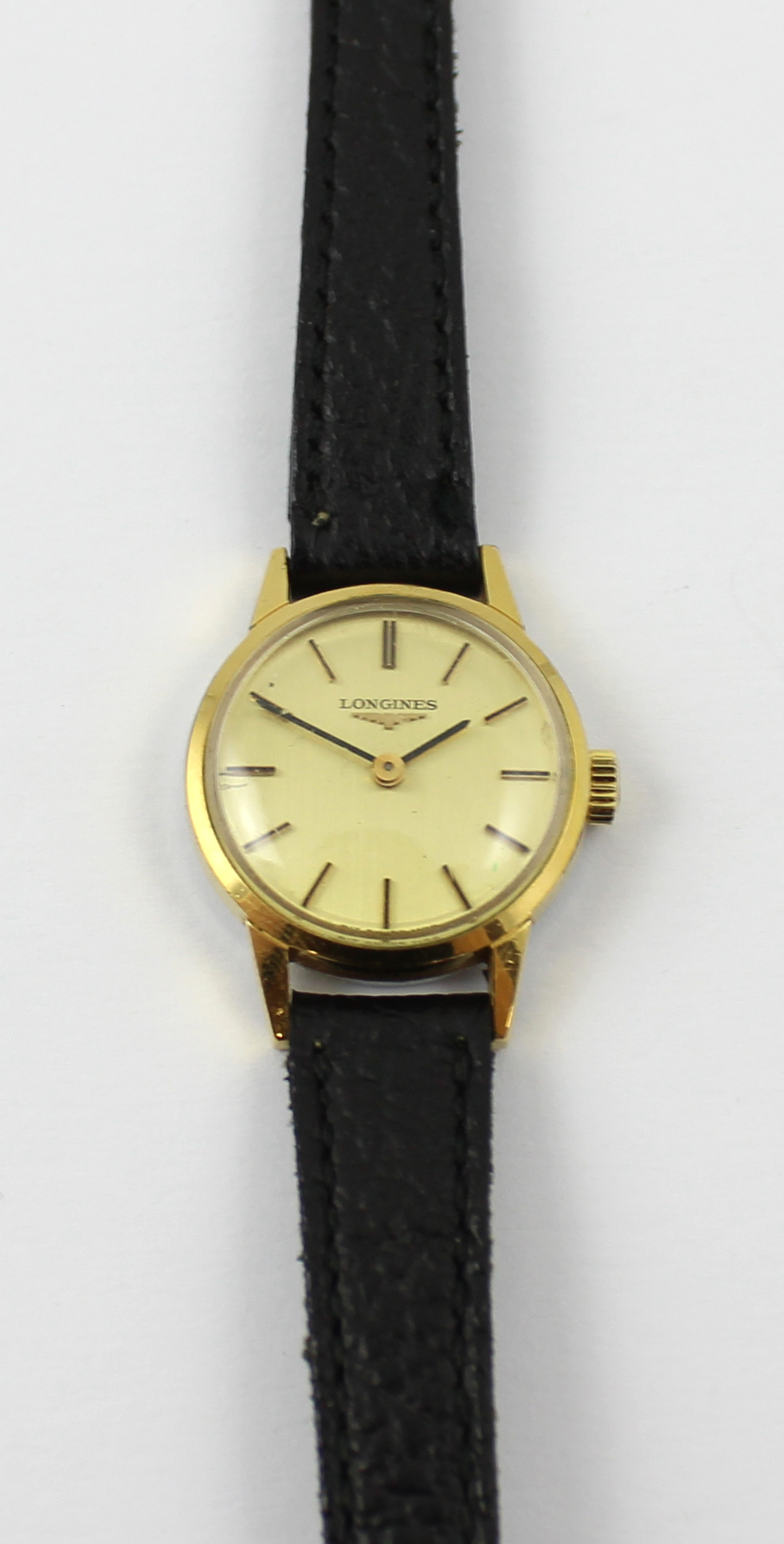 Longines; a ladies' yellow metal wristwatch the dial set with baton numerals,