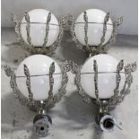 Four large ornate white metal wall lights, in the form of a brazier, with white opaque globe shades,