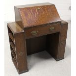 An early 20th century oak bureau with fall front and frieze drawer flanked by pedestals, width 90cm.