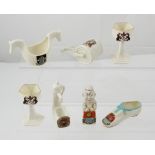 Seven items of crested ware by Goss, Shelley and Carlton to include a garden roller, a water pump,