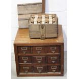 A vintage farm egg carrying box and an early 20th century mahogany filing cabinet with nine small