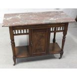 A late Victorian walnut wash stand with marbled top above door.