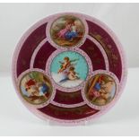 A late 19th century Vienna hand painted plate with vignettes of cherubs,