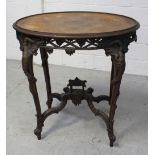 A late 19th/early 20th century Oriental hardwood oval side table, carved frieze of dragons,