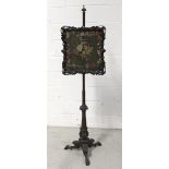 A 19th century mahogany pole screen with woolwork floral tapestry in carved acanthus and C-scroll