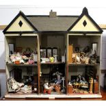 A mid-20th century twin-gabled, double-fronted dolls' house,