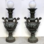 A pair of large bronze and verdigris metal decorative lamps,