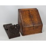 An Edwardian oak stationery box with sloped twin door enclosing fitted interior with perpetual