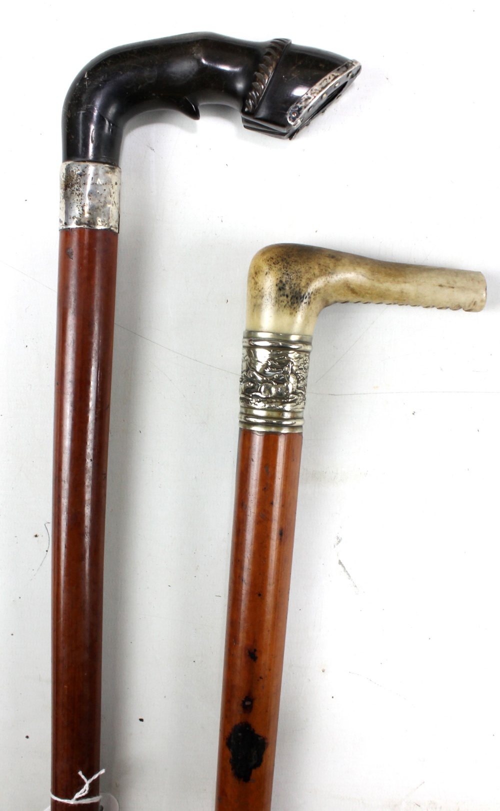 A Victorian malacca shafted hallmarked silver mounted walking stick with horn handle modelled as a