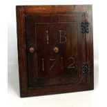 An early 18th century Welsh oak recess cupboard initialled IB to the door and dated 1712 with