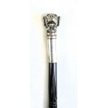 A Victorian carved ebony shafted walking stick with white metal mounts and initialled cartouche,