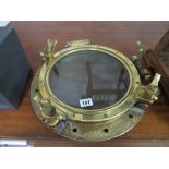 Large brass port hole mirror