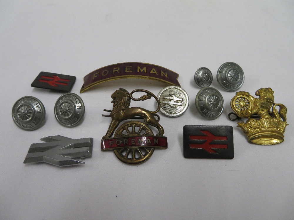 Box containing British rails and original cap badges and buttons